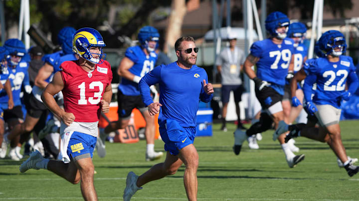 Jul 23, 2025; Los Angeles, CA, USA; Los Angeles Rams coach Sean McVay runs with quarterback Stetson Bennett (13) during training camp at Loyola Marymount University. Mandatory Credit: Kirby Lee-Imagn Images Jul 23, 2025; Los Angeles, CA, USA; Los Angeles Rams coach Sean McVay runs with quarterback Stetson Bennett (13) during training camp at Loyola Marymount University. Mandatory Credit: Kirby Lee-Imagn Images