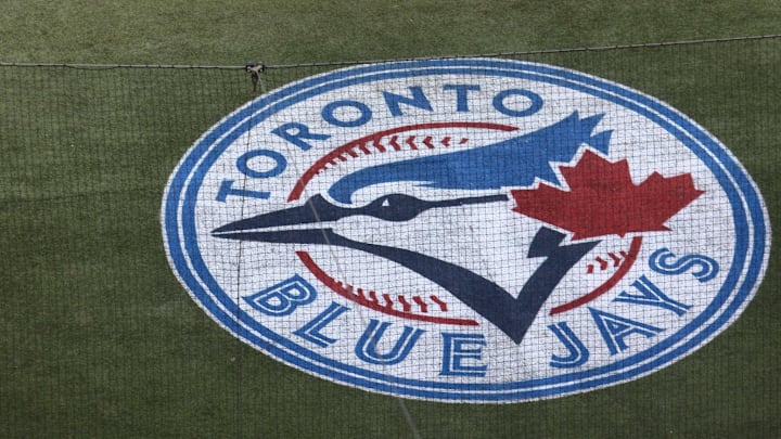 Apr 19, 2012; Toronto, ON, Canada; Toronto Blue Jays second baseman Kelly Johnson (2) swings as the new logo can be seen embedded on the turf behind home plate against the Tampa Bay Rays at the Rogers Centre. Mandatory Credit: Tom Szczerbowski-Imagn Images