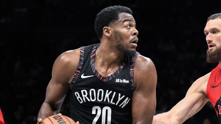 Dec 21, 2025; Brooklyn, New York, USA; Brooklyn Nets center Day'Ron Sharpe (20) looks to pass the ball as Toronto Raptors forward/center Sandro Mamukelashvili (54) defends during the first half at Barclays Center. Mandatory Credit: John Jones-Imagn Images