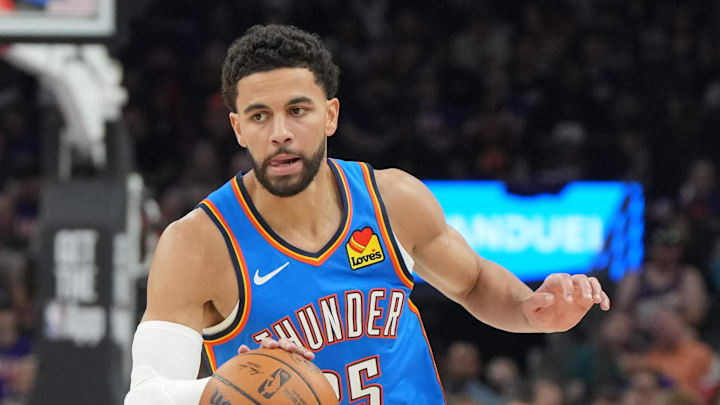 Apr 25, 2026; Phoenix, Arizona, USA; Oklahoma City Thunder guard Ajay Mitchell (25) drives against the Phoenix Suns in the first half during game three of the first round of the 2026 NBA Playoffs at Mortgage Matchup Center. Mandatory Credit: Rick Scuteri-Imagn Images