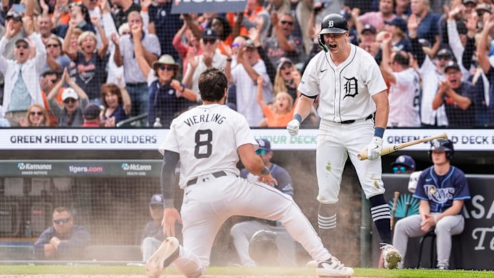 Detroit Tigers left fielder Matt Vierling slides to score a run against the Tampa Bay Rays as shortstop Trey Sweeney celebrates.