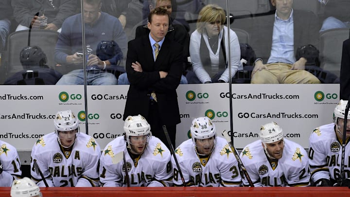 Feb 4 2013; Denver, CO, USA; Dallas Stars head coach Glen Gulutzan on his bench during the first period of the game against the Colorado Avalanche at the Pepsi Center. Mandatory Credit: Ron Chenoy-Imagn Images