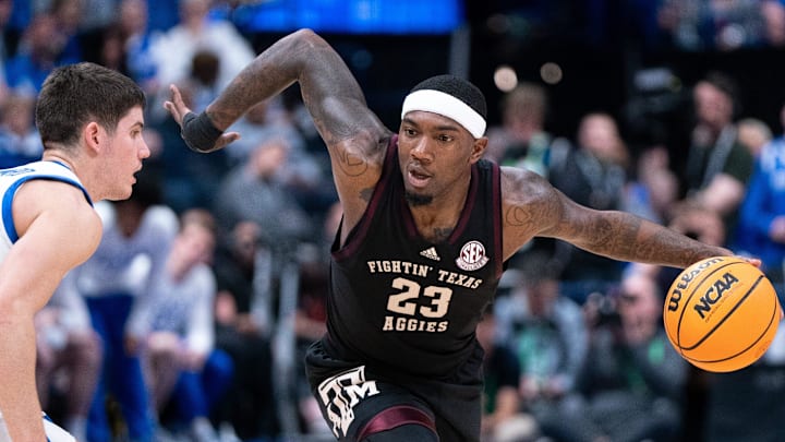 Texas A&M Aggies guard Tyrece Radford (23) drives around Kentucky Wildcats guard Reed Sheppard