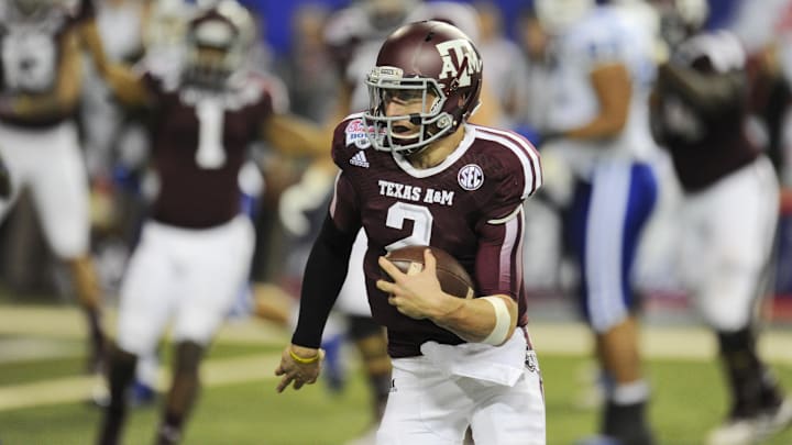 Dec 31, 2013; Atlanta, GA, USA;  Texas A&M Aggies quarterback Johnny Manziel (2) carries the ball for a three yard touchdown against the Duke Blue Devils in the 2013 Chick-fil-a Bowl at the Georgia Dome. Mandatory Credit: Dale Zanine-Imagn Images
