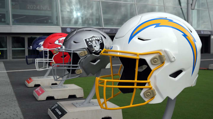 Large helmets of the Los Angeles Chargers, Las Vegas Raiders, Kansas City Chiefs and Denver Broncos of the AFC West before an NFL International Series game at Tottenham Hotspur Stadium. 