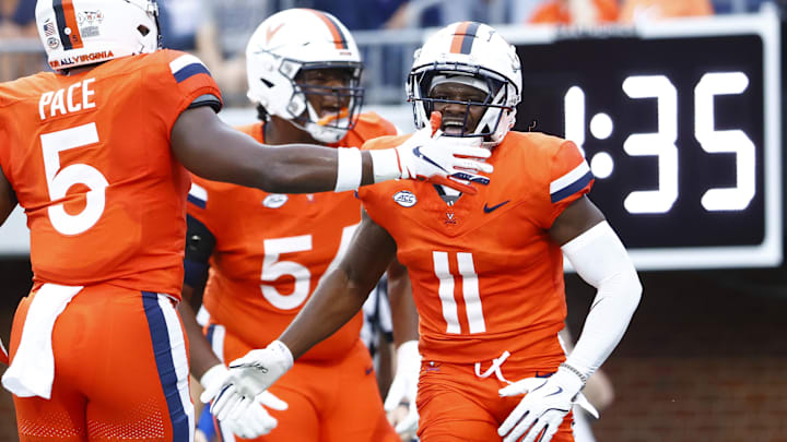Aug 31, 2024; Charlottesville, Virginia, USA; Virginia Cavaliers wide receiver Trell Harris (11) celebrates with Cavaliers running back Kobe Pace (5) after scoring a touchdown against the Richmond Spiders during the first half at Scott Stadium. Mandatory Credit: Amber Searls-Imagn Images