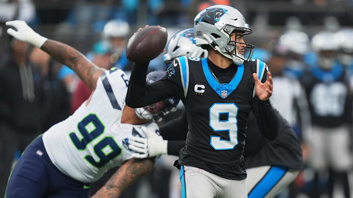 Dec 28, 2025; Charlotte, North Carolina, USA; Carolina Panthers quarterback Bryce Young (9) throws a pass against Seattle Seahawks defensive end Leonard Williams (99) during the first quarter at Bank of America Stadium. Mandatory Credit: Jim Dedmon-Imagn Images