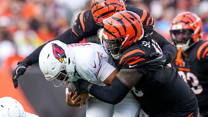 Cincinnati Bengals defensive tackle T.J. Slaton Jr. (98) pulls down Arizona Cardinals quarterback Jacoby Brissett (7) in the third quarter of the NFL Week 17 game between the Cincinnati Bengals and the Arizona Cardinals at Paycor Stadium in Downtown Cincinnati on Sunday, Dec. 28, 2025. The Bengals won 37-14.