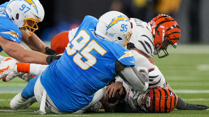 Nov 17, 2024; Inglewood, CA, USA; Cincinnati Bengals quarterback Joe Burrow (9) is sacked by Los Angeles Chargers defensive tackle Poona Ford (95) in the second quarter of the NFL Week 11 game between the Los Angeles Chargers and the Cincinnati Bengals at SoFi Stadium in Inglewood, Calif., on Sunday, Nov. 17, 2024. The Chargers led 24-6 at halftime. Mandatory Credit: Sam Greene/USA TODAY Network via Imagn Images Nov 17, 2024; Inglewood, CA, USA; Cincinnati Bengals quarterback Joe Burrow (9) is sacked by Los Angeles Chargers defensive tackle Poona Ford (95) in the second quarter of the NFL Week 11 game between the Los Angeles Chargers and the Cincinnati Bengals at SoFi Stadium in Inglewood, Calif., on Sunday, Nov. 17, 2024. The Chargers led 24-6 at halftime. Mandatory Credit: Sam Greene/USA TODAY Network via Imagn Images