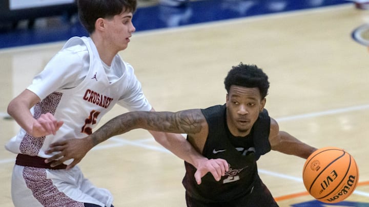 Peoria High's Anthony Sturdivant III (4) moves the ball against Chicago Brother Rice's Max Justice in the first half of the Class 3A boys basketball Pontiac Super-Sectional on Monday, March 10, 2025 at Pontiac Township High School. The Lions fell 60-41.