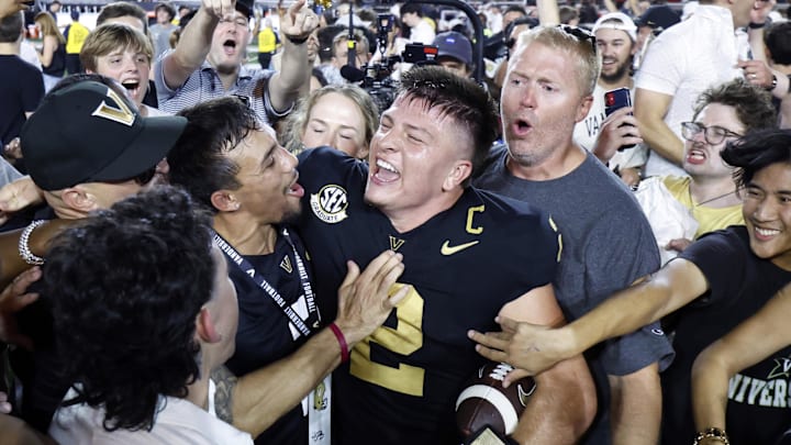 Vanderbilt quarterback Diego Pavia celebrates with fans after defeating Alabama.