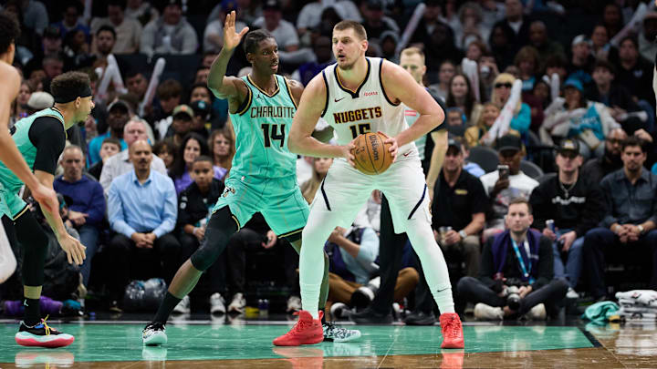 Feb 1, 2025; Charlotte, North Carolina, USA; Denver Nuggets center Nikola Jokic (15) is defended by Charlotte Hornets forward Moussa Diabate (14) during the second half of play at Spectrum Center. Mandatory Credit: Brian Westerholt-Imagn Images