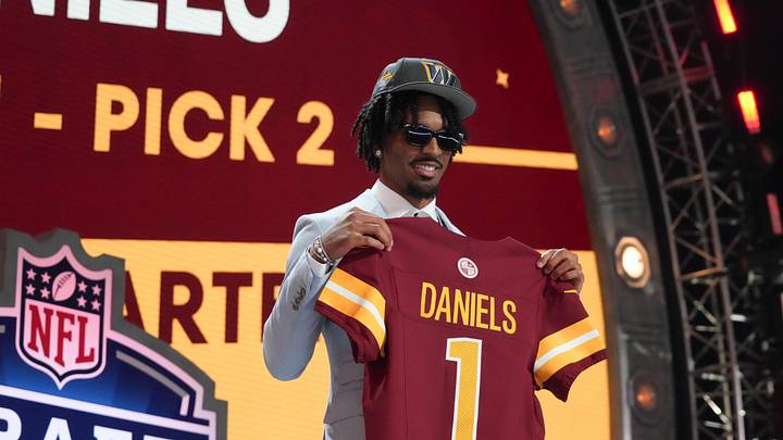Apr 25, 2024; Detroit, MI, USA; LSU Tigers quarterback Jayden Daniels poses after being selected by the Washington Commanders as the No. 2 pick in the first round of the 2024 NFL Draft at Campus Martius Park and Hart Plaza. Mandatory Credit: Kirby Lee-Imagn Images