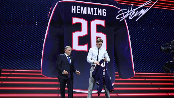 Jun 26, 2026; Buffalo, New York, USA; Oscar Hemming reacts beside NHL commissioner Gary Bettman after being selected with the fourteenth pick in the first round of the 2026 NHL Draft by the Columbus Blue Jackets at KeyBank Center. Mandatory Credit: Timothy T. Ludwig-Imagn Images