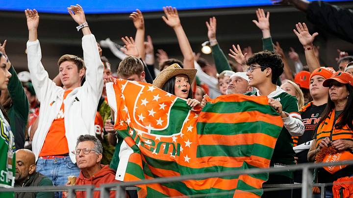 Miami Hurricanes fans cheer during the Cotton Bowl at AT&T Stadium in Arlington, Texas for the College Football Playoff quarterfinal game against the Ohio State Buckeyes on Dec. 31, 2025. Ohio State lost 24-14.