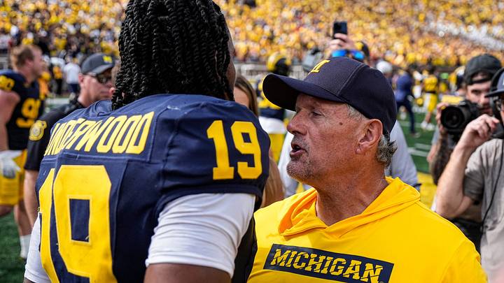 Michigan quarterback Bryce Underwood (19) talks to head coach Kyle Whittingham to celebrate 17-10 win over Oklahoma at Michigan Stadium in Ann Arbor on Saturday, Sept. 12, 2026. Michigan quarterback Bryce Underwood (19) talks to head coach Kyle Whittingham to celebrate 17-10 win over Oklahoma at Michigan Stadium in Ann Arbor on Saturday, Sept. 12, 2026.
