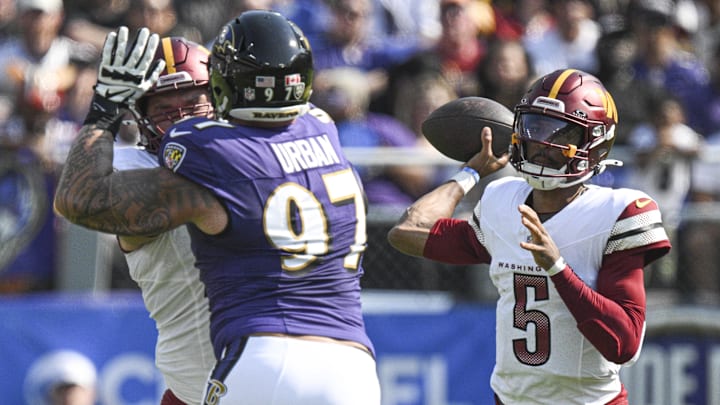 Jayden Daniels gets set to throw over Ravens defensive lineman Brent Urban in Sunday's 30-23 Baltimore win.