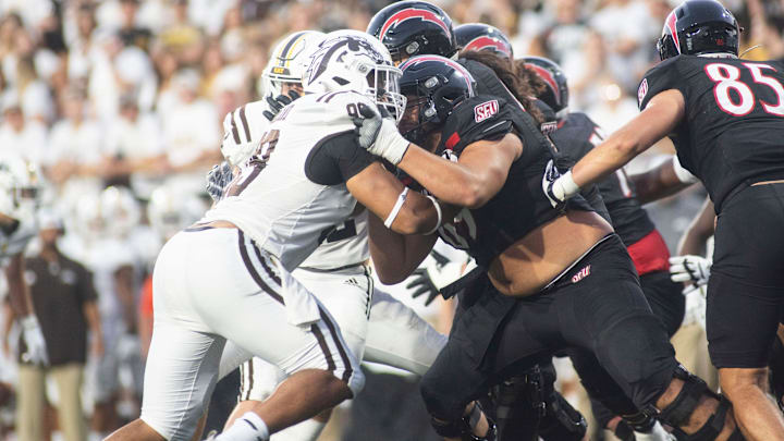 Western Michigan lineman Marshawn Kneeland clashes with Saint Francis offense during the season