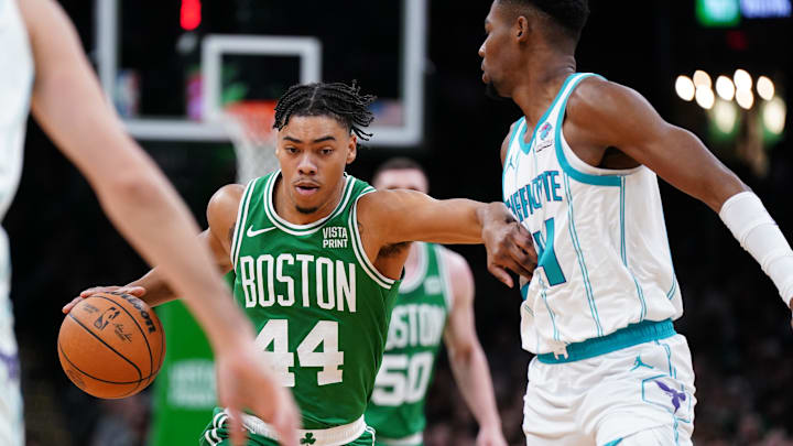 Apr 12, 2024; Boston, Massachusetts, USA; Boston Celtics guard Jaden Springer (44) returns the ball against Charlotte Hornets forward Brandon Miller (24) in the first quarter at TD Garden. Mandatory Credit: David Butler II-Imagn Images