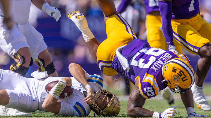 Sep 21, 2024; Baton Rouge, Louisiana, USA;  UCLA Bruins quarterback Ethan Garbers (4) is sacked by LSU Tigers defensive tackle Ahmad Breaux (93) during the first half at Tiger Stadium. Mandatory Credit: Stephen Lew-Imagn Images