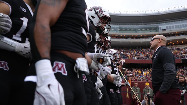 Nov 1, 2025; Minneapolis, Minnesota, USA; Minnesota Golden Gophers head coach P.J. Fleck leads his team onto the field before the game against the Michigan State Spartans at Huntington Bank Stadium. Mandatory Credit: Matt Krohn-Imagn Images