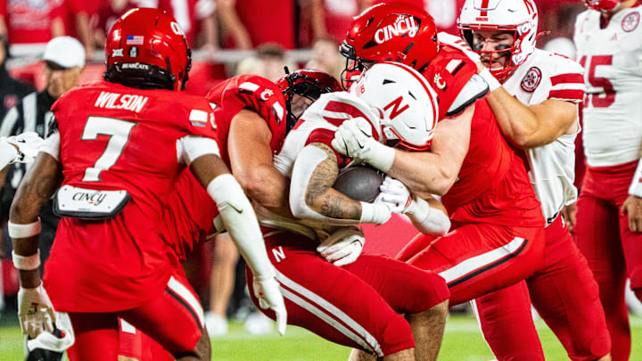 Aug 28, 2025; Kansas City, Missouri, USA; Nebraska Cornhuskers running back Kenneth Williams (25) is tackled by Cincinnati Bearcats defenders during the second quarter at GEHA Field at Arrowhead Stadium. Mandatory Credit: Dylan Widger-Imagn Images Aug 28, 2025; Kansas City, Missouri, USA; Nebraska Cornhuskers running back Kenneth Williams (25) is tackled by Cincinnati Bearcats defenders during the second quarter at GEHA Field at Arrowhead Stadium. Mandatory Credit: Dylan Widger-Imagn Images