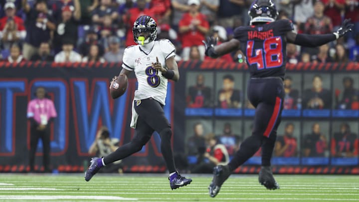 Baltimore Ravens quarterback Lamar Jackson (8) scrambles with the ball during the second quarter against the Houston Texans at NRG Stadium. 