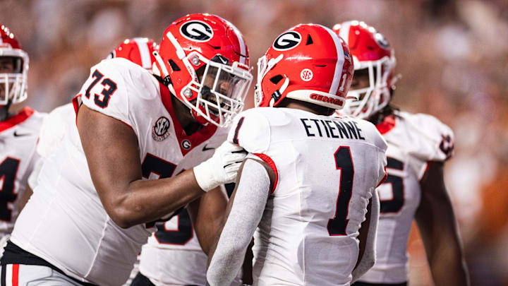 Oct 19, 2024; Austin, Texas, USA; Georgia Bulldogs running back Trevor Etienne (1) celebrates with offensive lineman Xavier Truss (73) after scoring a touchdown against the Texas Longhorns during the second quarter at Darrell K Royal-Texas Memorial Stadium. Mandatory Credit: Brett Patzke-Imagn Images