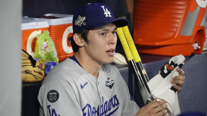 Oct 31, 2025; Toronto, Ontario, CAN; Los Angeles Dodgers pitcher Roki Sasaki (11) looks on in the dugout against the Toronto Blue Jays in the eighth inning during game six of the 2025 MLB World Series at Rogers Centre. Mandatory Credit: John E. Sokolowski-Imagn Images Oct 31, 2025; Toronto, Ontario, CAN; Los Angeles Dodgers pitcher Roki Sasaki (11) looks on in the dugout against the Toronto Blue Jays in the eighth inning during game six of the 2025 MLB World Series at Rogers Centre. Mandatory Credit: John E. Sokolowski-Imagn Images
