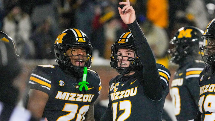 Nov 30, 2024; Columbia, Missouri, USA; Missouri Tigers quarterback Brady Cook (12) celebrates with running back Jamal Roberts (20) after scoring the game-winning touchdown against the Arkansas Razorbacks during the first half at Faurot Field at Memorial Stadium. Mandatory Credit: Denny Medley-Imagn Images Nov 30, 2024; Columbia, Missouri, USA; Missouri Tigers quarterback Brady Cook (12) celebrates with running back Jamal Roberts (20) after scoring the game-winning touchdown against the Arkansas Razorbacks during the first half at Faurot Field at Memorial Stadium. Mandatory Credit: Denny Medley-Imagn Images