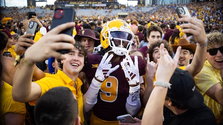 Nov 23, 2024; Tempe, Arizona, USA; Arizona State Sun Devils wide receiver Troy Omeire (9) celebrates with fans on the field against the Brigham Young Cougars in the second half at Mountain America Stadium. Mandatory Credit: Mark J. Rebilas-Imagn Images