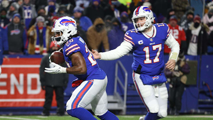 Bills Zack Moss takes a hand off by Josh Allen. Bills Zack Moss takes a hand off by Josh Allen.