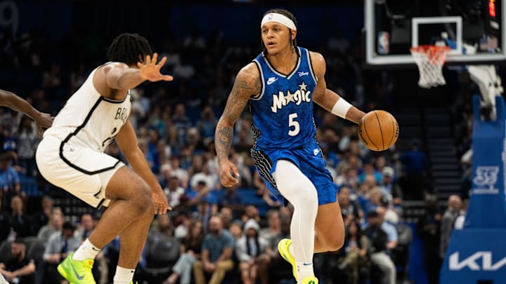 Orlando Magic forward Paolo Banchero (5) dribbles the ball against Brooklyn Nets guard Cam Thomas (24) in the third quarter at Kia Center.