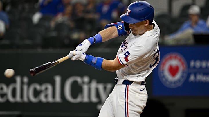 May 2, 2024; Arlington, Texas, USA; Texas Rangers center fielder Evan Carter (32) hits a singles and drives in a run against the Washington Nationals during the second inning at Globe Life Field.