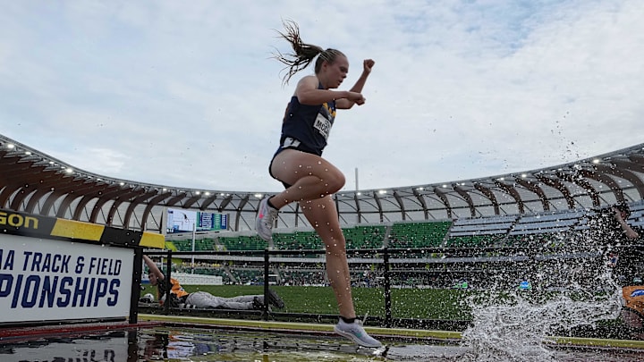 Jun 9, 2022; Eugene, OR, USA; Ceili McCabe of West Virginia races over the water jump in the women's steeplechase during the NCAA Track and Field Championships at Hayward Field. Mandatory Credit: Kirby Lee-Imagn Images