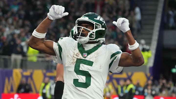 Oct 6, 2024; London, United Kingdom; New York Jets wide receiver Garrett Wilson (5) celebrates after scoring on a 1-yard touchdown reception against the New York Jets in the fourth quarter at Tottenham Hotspur Stadium.