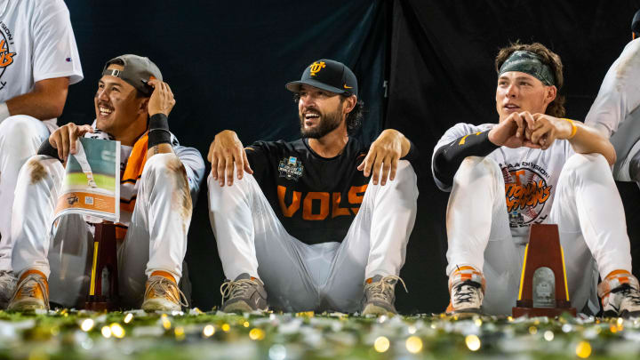 Jun 24, 2024; Omaha, NE, USA; Tennessee Volunteers center fielder Hunter Ensley (9), head coach Tony Vitello and third baseman Billy Amick (11) watch a video during postgame ceremonies after defeating the Texas A&M Aggies in the championship at Charles Schwab Field Omaha. Mandatory Credit: Dylan Widger-USA TODAY Sports