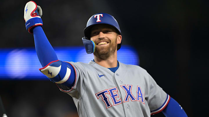 Texas Rangers left fielder Brandon Nimmo (24) reacts towards the dugout after hitting a single during the third inning against the Los Angeles Dodgers at Dodger Stadium. 