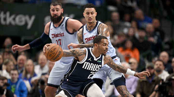 Jan 27, 2025; Dallas, Texas, USA; Dallas Mavericks forward P.J. Washington (25) looks to moves the ball past Washington Wizards forward Kyle Kuzma (33) during the second half at the American Airlines Center. Mandatory Credit: Jerome Miron-Imagn Images