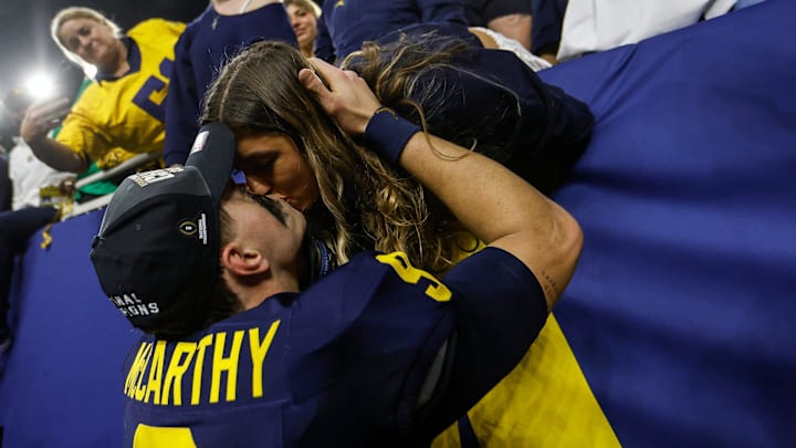 Then-Michigan quarterback J.J. McCarthy kisses his girlfriend Katya Kuropas to celebrate the Wolverines' 34-13 win over Washington to win the national championship at NRG Stadium in Houston on Monday, Jan. 8, 2024. Then-Michigan quarterback J.J. McCarthy kisses his girlfriend Katya Kuropas to celebrate the Wolverines' 34-13 win over Washington to win the national championship at NRG Stadium in Houston on Monday, Jan. 8, 2024.