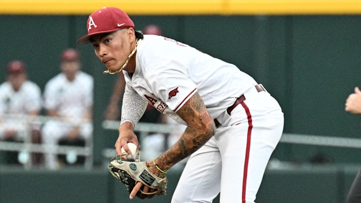 Arkansas Razorbacks shortstop Wehiwa Aloy (9) fields a ground ball against the UCLA Bruins during the sixth inning at Charles Schwab Field. Arkansas Razorbacks shortstop Wehiwa Aloy (9) fields a ground ball against the UCLA Bruins during the sixth inning at Charles Schwab Field.