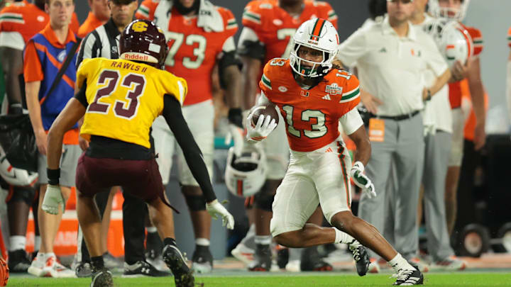 Sep 6, 2025; Miami Gardens, Florida, USA; Miami Hurricanes wide receiver Daylyn Upshaw (13) runs with the football against Bethune-Cookman Wildcats safety Nichalas Rawls II (23) during the fourth quarter at Hard Rock Stadium. Mandatory Credit: Sam Navarro-Imagn Images