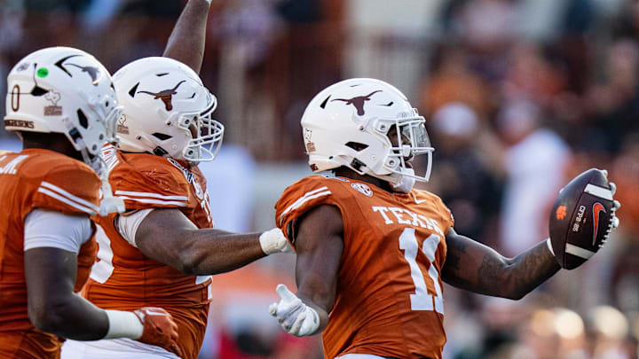 Texas Longhorns linebacker Colin Simmons (11) celebrates an interception in the second quarter as the Texas Longhorns play the Clemson Tigers in the first round of the College Football Playoffs at Darrell K Royal Texas Memorial Stadium in Austin, Texas, Dec. 21, 2024.