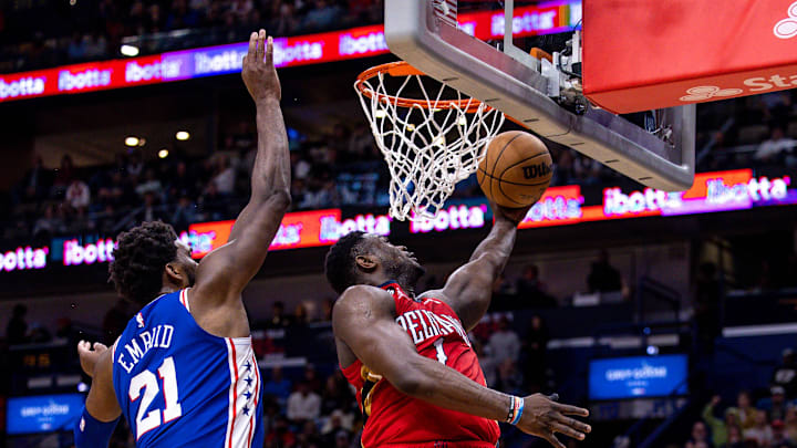 Dec 30, 2022; New Orleans, Louisiana, USA; New Orleans Pelicans forward Zion Williamson (1) drives to the basket against Philadelphia 76ers center Joel Embiid (21) during the second half at Smoothie King Center. Mandatory Credit: Stephen Lew-Imagn Images