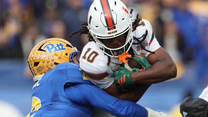 Nov 29, 2025; Pittsburgh, Pennsylvania, USA; Miami Hurricanes wide receiver Malachi Toney (10) runs after a catch as Pittsburgh Panthers defensive end Isaiah Neal (2) tackles during the first quarter at Acrisure Stadium. Mandatory Credit: Charles LeClaire-Imagn Images Nov 29, 2025; Pittsburgh, Pennsylvania, USA; Miami Hurricanes wide receiver Malachi Toney (10) runs after a catch as Pittsburgh Panthers defensive end Isaiah Neal (2) tackles during the first quarter at Acrisure Stadium. Mandatory Credit: Charles LeClaire-Imagn Images