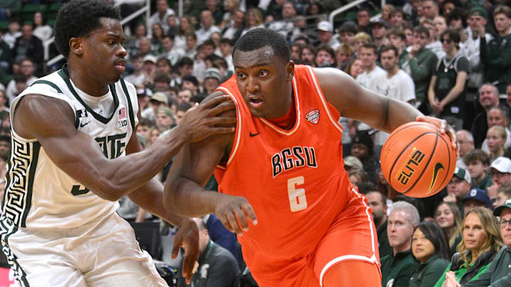 Nov 16, 2024; East Lansing, Michigan, USA;  Bowling Green Falcons forward Marcus Johnson (6) drives against Michigan State Spartans forward Coen Carr (55) during the first half at Jack Breslin Student Events Center. Mandatory Credit: Dale Young-Imagn Images