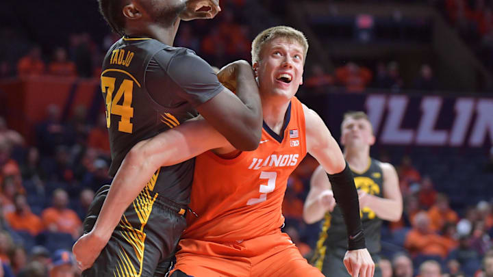 Feb 25, 2025; Champaign, Illinois, USA;  Iowa Hawkeyes forward Chris Tadjo (34) and Illinois Fighting Illini forward Ben Humrichous (3) battle for position during the second half at State Farm Center. Mandatory Credit: Ron Johnson-Imagn Images
