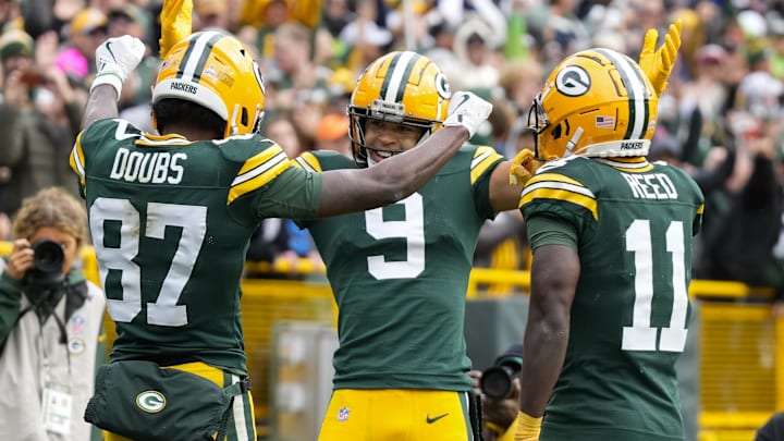 Oct 13, 2024; Green Bay, Wisconsin, USA;  Green Bay Packers wide receiver Romeo Doubs (87) celebrates with wide receivers Christian Watson (9) and Jayden Reed (11) after scoring a touchdown during the third quarter against the Arizona Cardinals at Lambeau Field. Mandatory Credit: Jeff Hanisch-Imagn Images