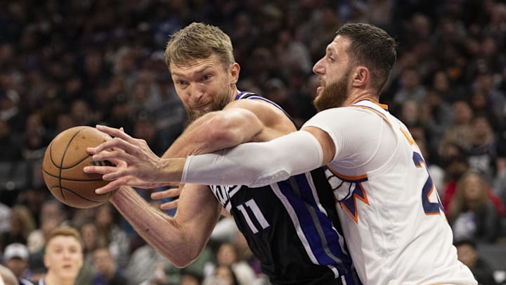 November 13, 2024; Sacramento, California, USA; Sacramento Kings forward Domantas Sabonis (11) is defended by Phoenix Suns center Jusuf Nurkic (20) during the second quarter at Golden 1 Center. Mandatory Credit: Kyle Terada-Imagn Images