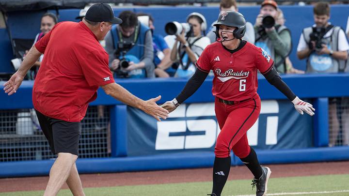 Jun 1, 2026; Oklahoma City, OK, USA; Texas Tech Red Raiders third baseman Taylor Pannell (6) slaps hands with head coach Gerry Glasco after hitting a two run home run in the fifth inning against the Texas Tech Red Raiders during the NCAA Women’s College World Series at Devon Park. Mandatory Credit: Brett Rojo-Imagn Images Jun 1, 2026; Oklahoma City, OK, USA; Texas Tech Red Raiders third baseman Taylor Pannell (6) slaps hands with head coach Gerry Glasco after hitting a two run home run in the fifth inning against the Texas Tech Red Raiders during the NCAA Women’s College World Series at Devon Park. Mandatory Credit: Brett Rojo-Imagn Images